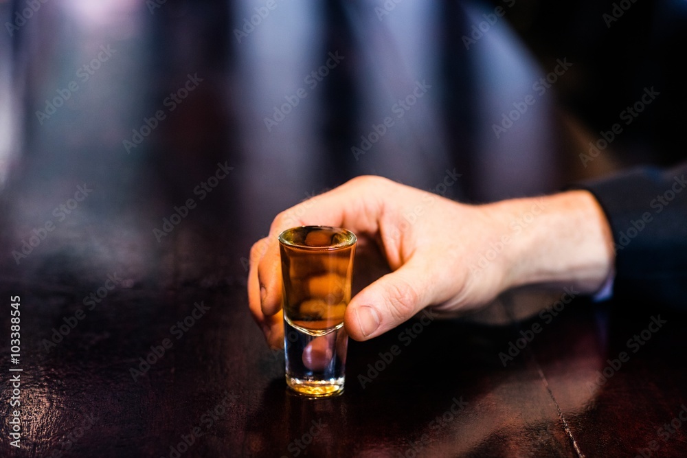 Man holding a shot Man holding a shot