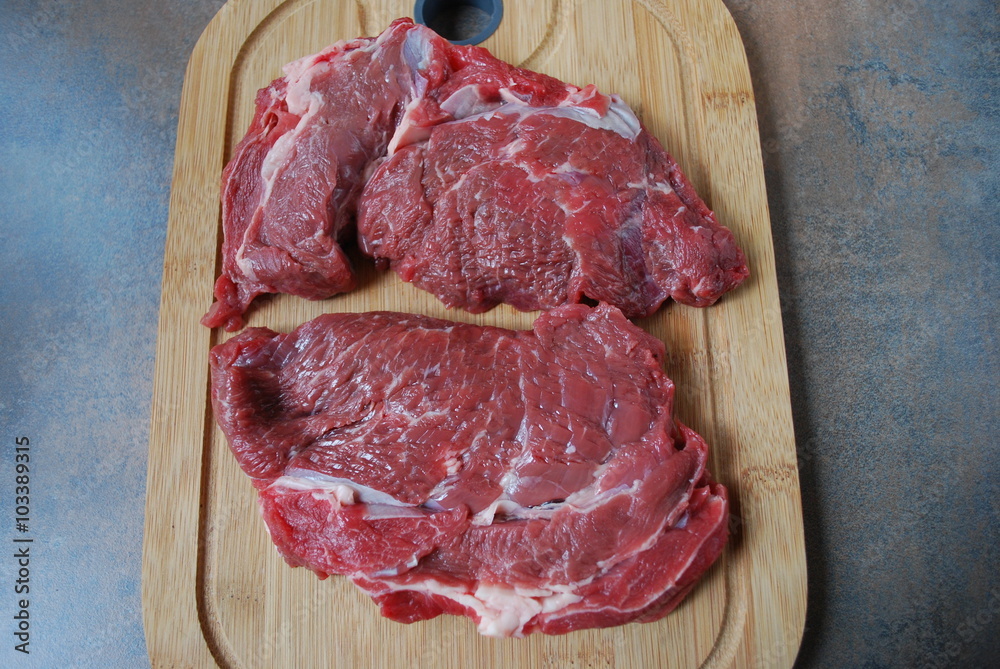 Fresh beef steak on a cutting board.