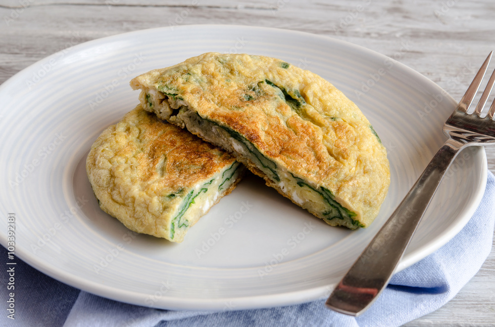 Omelet with spinach on plate Omelet with spinach on plate