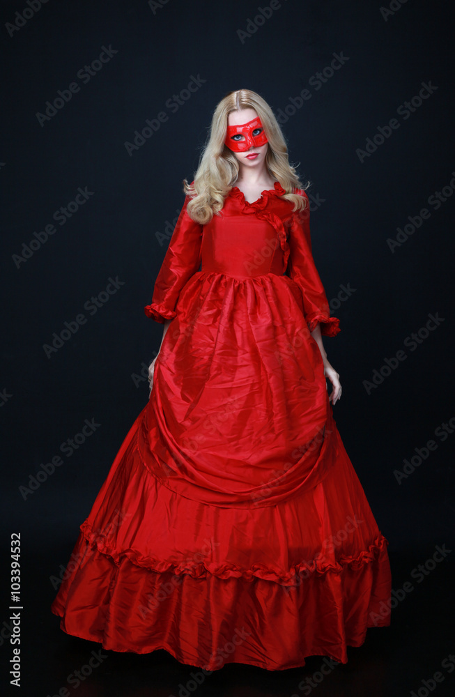 full length portrait of a beautiful blonde woman wearing a historical red silk, victorian era ball gown. full length portrait of a beautiful blonde woman wearing a historical red silk, victorian era ball gown.