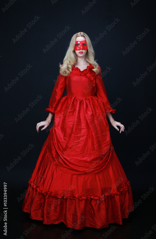 full length portrait of a beautiful blonde woman wearing a historical red silk, victorian era ball gown. full length portrait of a beautiful blonde woman wearing a historical red silk, victorian era ball gown.