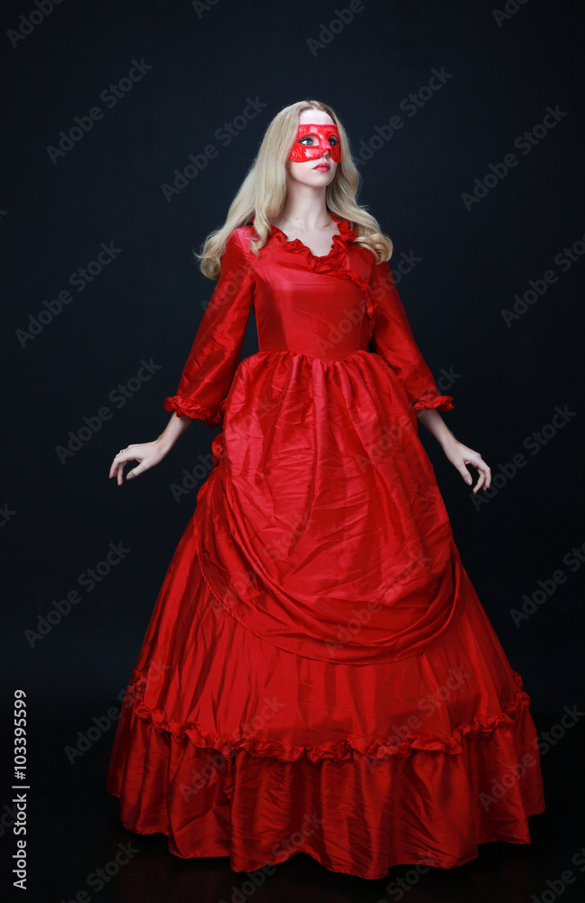 full length portrait of a beautiful blonde woman wearing a historical red silk, victorian era ball gown. full length portrait of a beautiful blonde woman wearing a historical red silk, victorian era ball gown.
