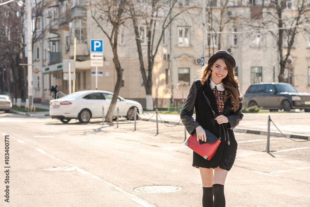 Beautiful brunette girl in stylish dress crosses the street Beautiful brunette girl in stylish dress crosses the street