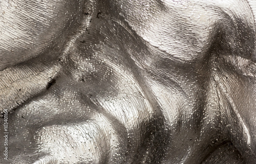 Background texture of the shining metal surface. The curved plate is made of iron.