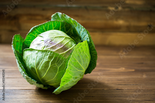 Fotografija Fresh green garden cabbage on rustic wooden background