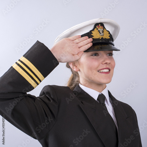 Canvas Print Portrait of a young female naval officer saluting