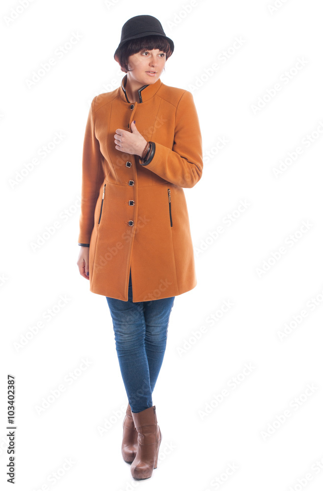 Beautiful young woman in orange coat posing on a white background. Beautiful young woman in orange coat posing on a white background.
