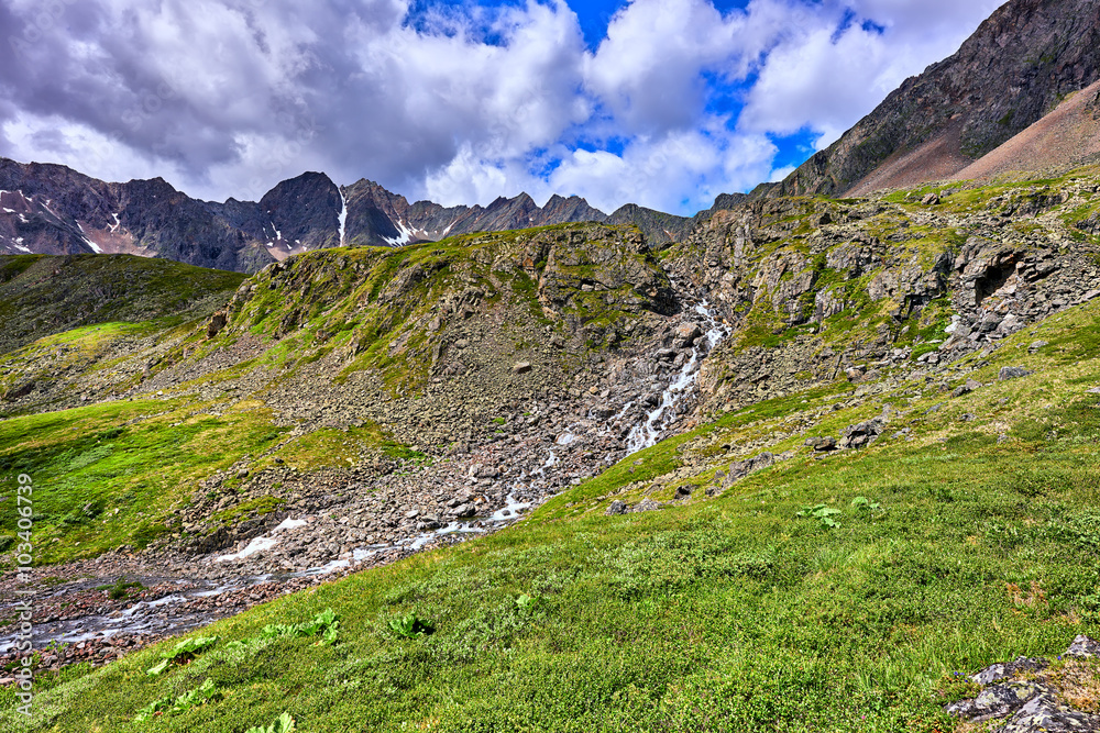 Mountain stream flows from a narrow canyon