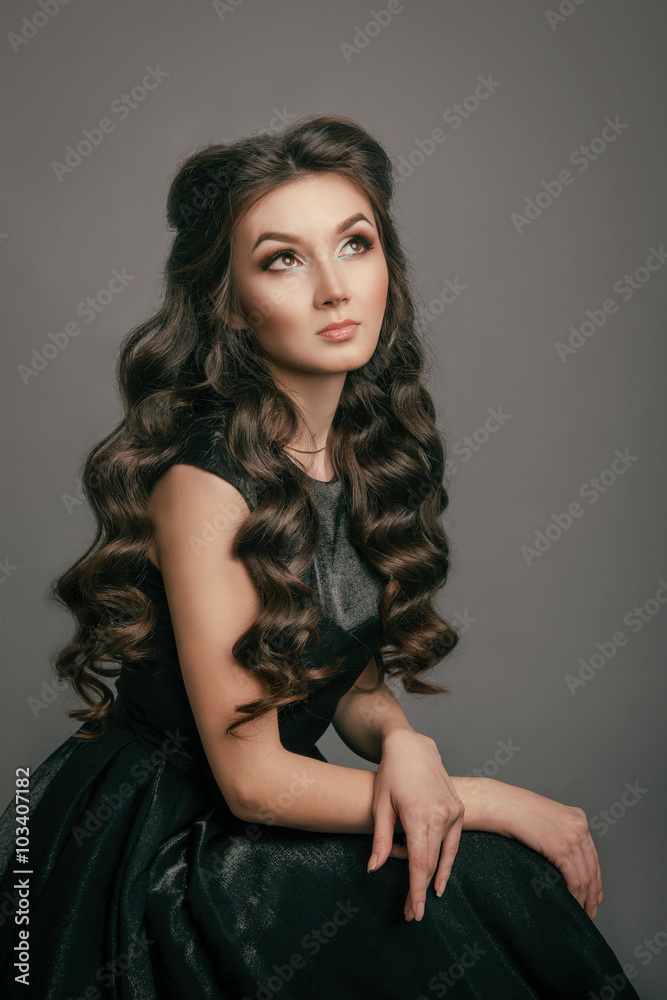 Curly girl looking up while sitting in the Studio