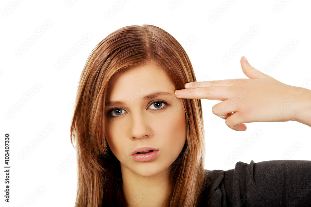 Teenage woman committing suicide with finger gun gesture Teenage woman committing suicide with finger gun gesture