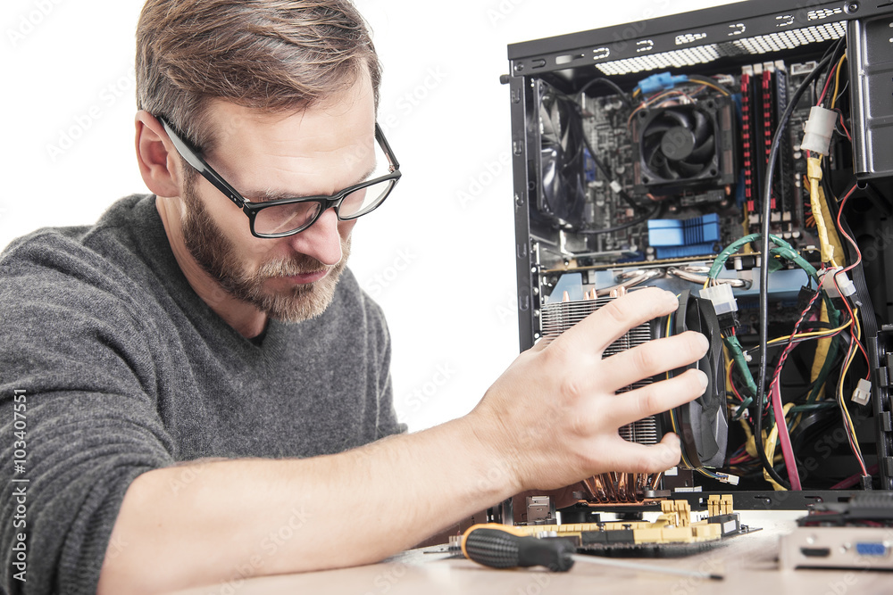 Computer technician installs cooling system. Computer technician installs cooling system.