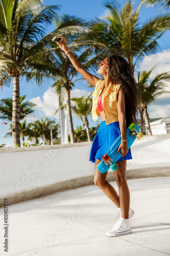 Beautiful teenage black girl in blue skirt take selfie with her