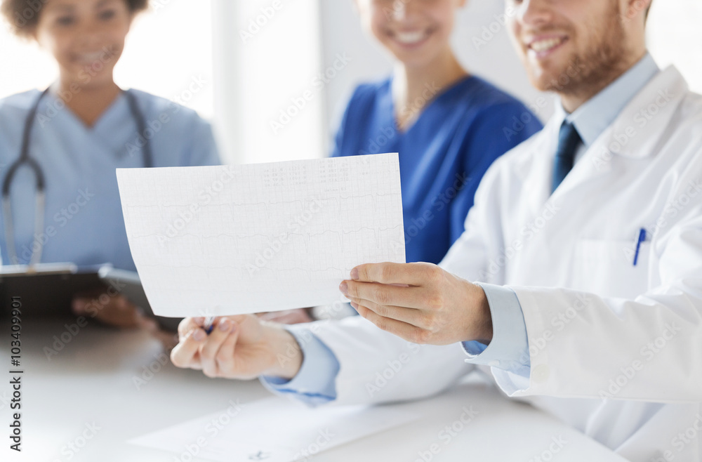 Fototapeta premium close up of doctors with cardiogram at hospital 
