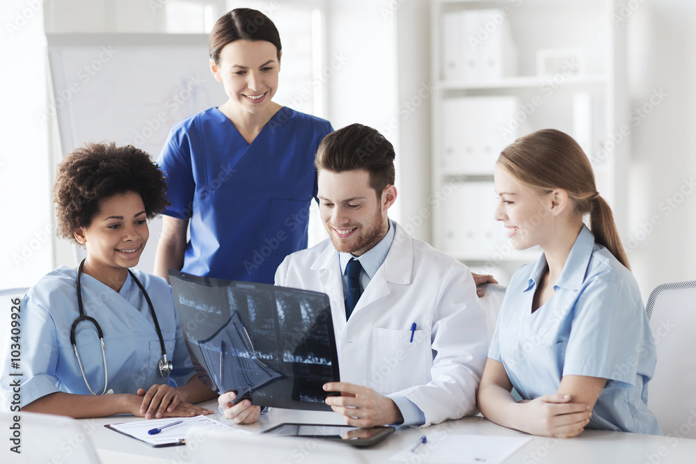 group of happy doctors discussing x-ray image group of happy doctors discussing x-ray image