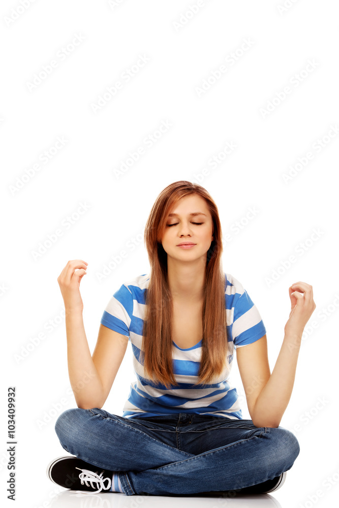Teenage woman meditation on the floor Teenage woman meditation on the floor