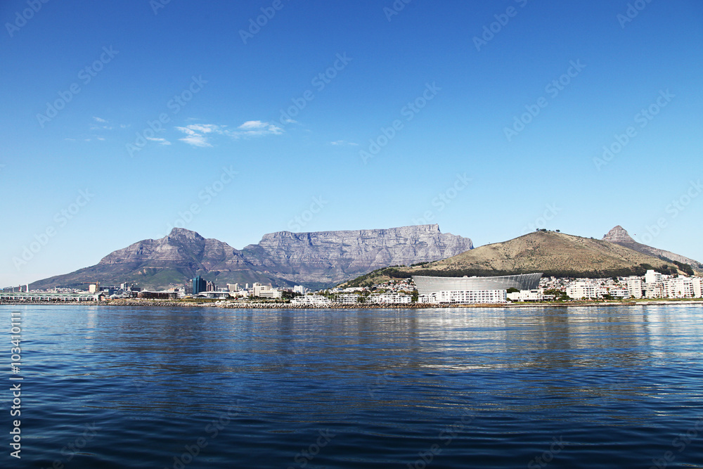 Cape Town, South Africa - Stadium and Waterfront and harbour with Table Mountain in the background.
