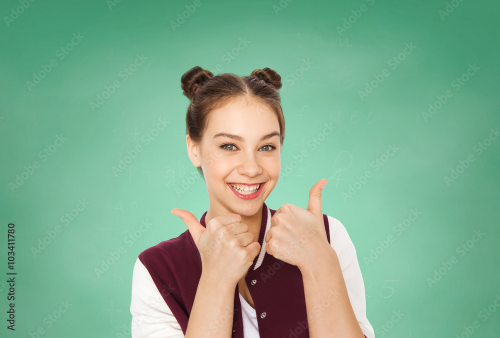 Fototapeta premium happy teenage student girl showing thumbs up