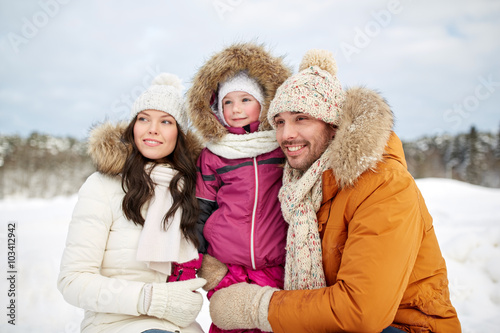 happy family with child in winter clothes outdoors