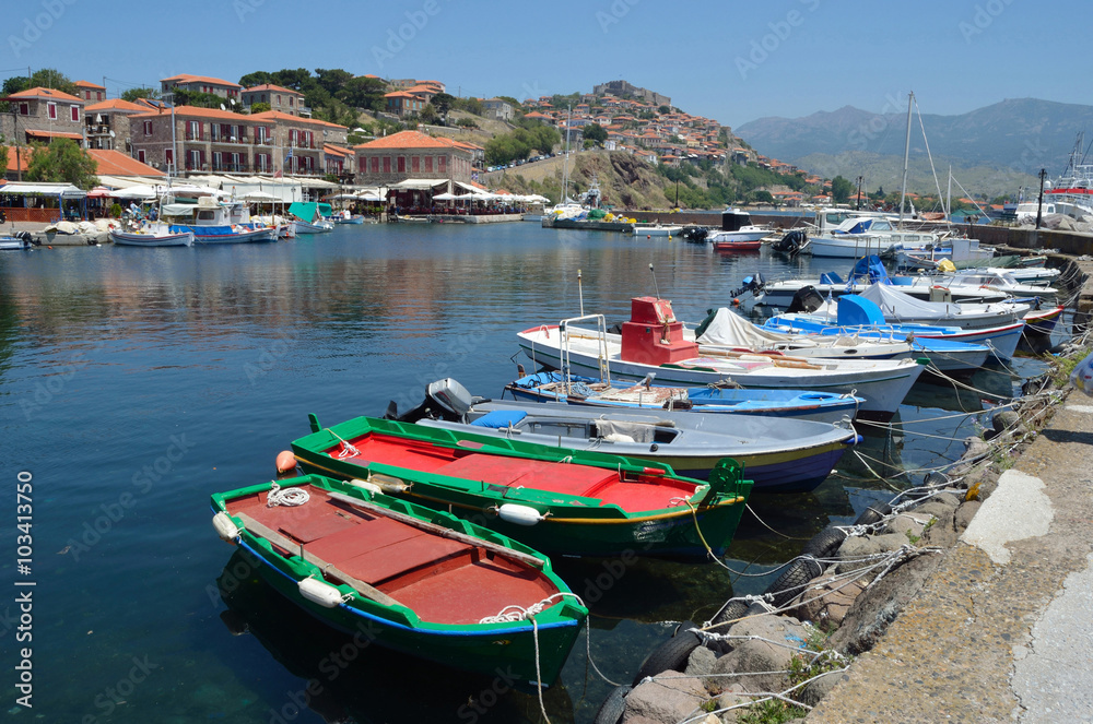 Molyvos Harbor with boats and castle in background on the island of Lesvos Greece
