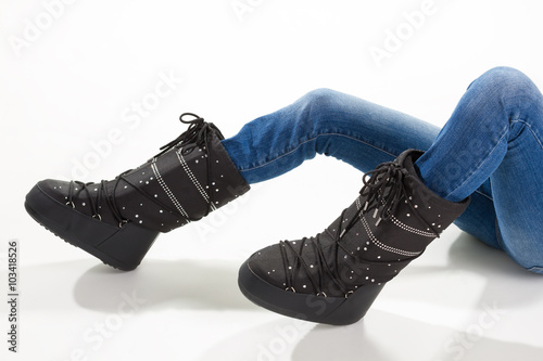 Girl lying in the moon boots.