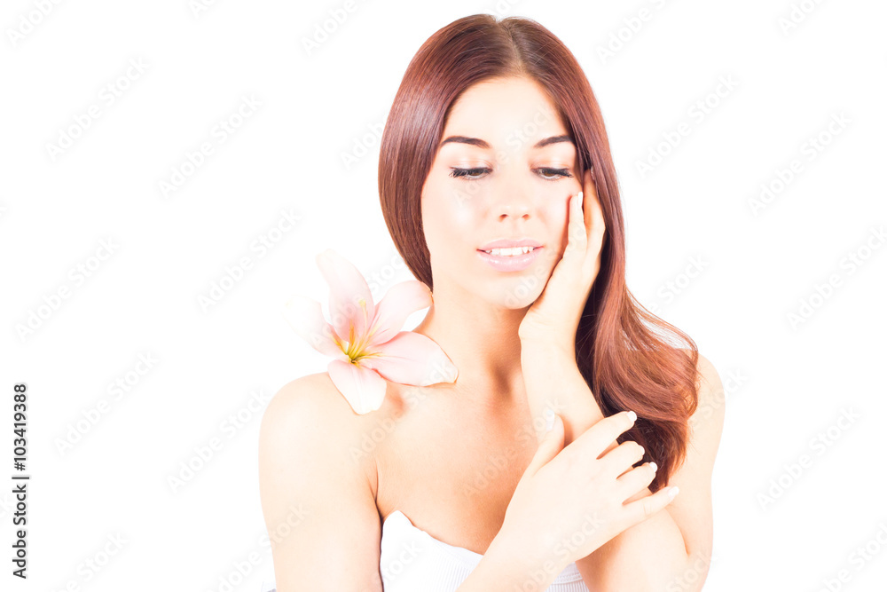 Beautiful woman with lily looking down and toching her cheek. SPA treatment. Beautiful woman with lily looking down and toching her cheek. SPA treatment.