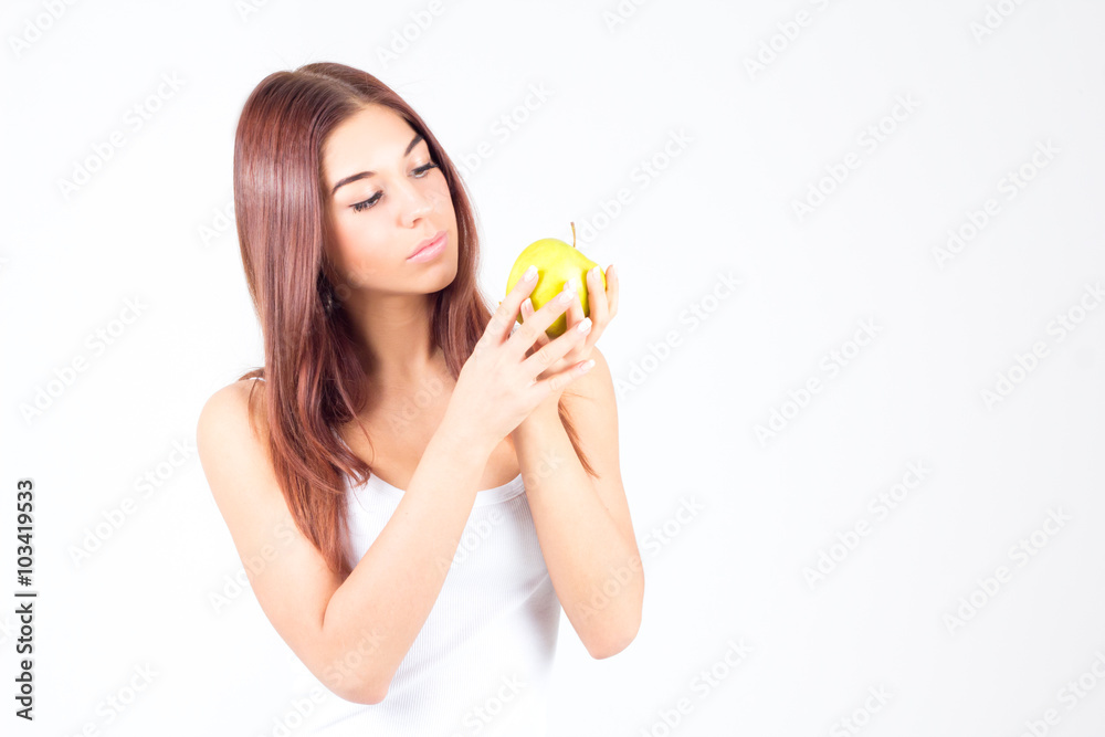 Beautiful woman looking at apple in her hands. Healthy lifestyle. Beautiful woman looking at apple in her hands. Healthy lifestyle.