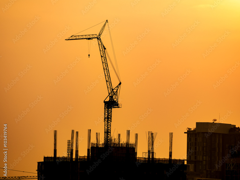 silhouette of construction crane on sunset sky
