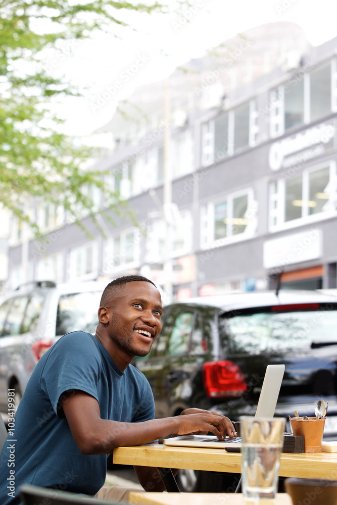Young african guy at cafe with a laptop Young african guy at cafe with a laptop