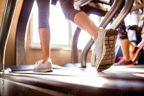 Detail of legs of woman running on treadmills gym