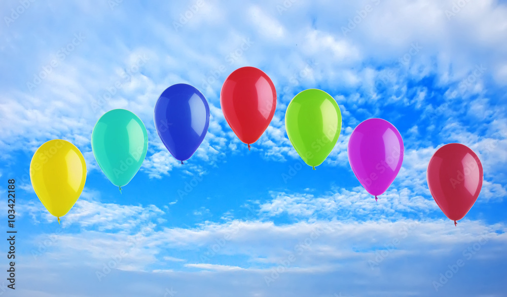 Colorful bright balloons on blue sky