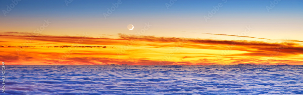 New Moon above evening clouds