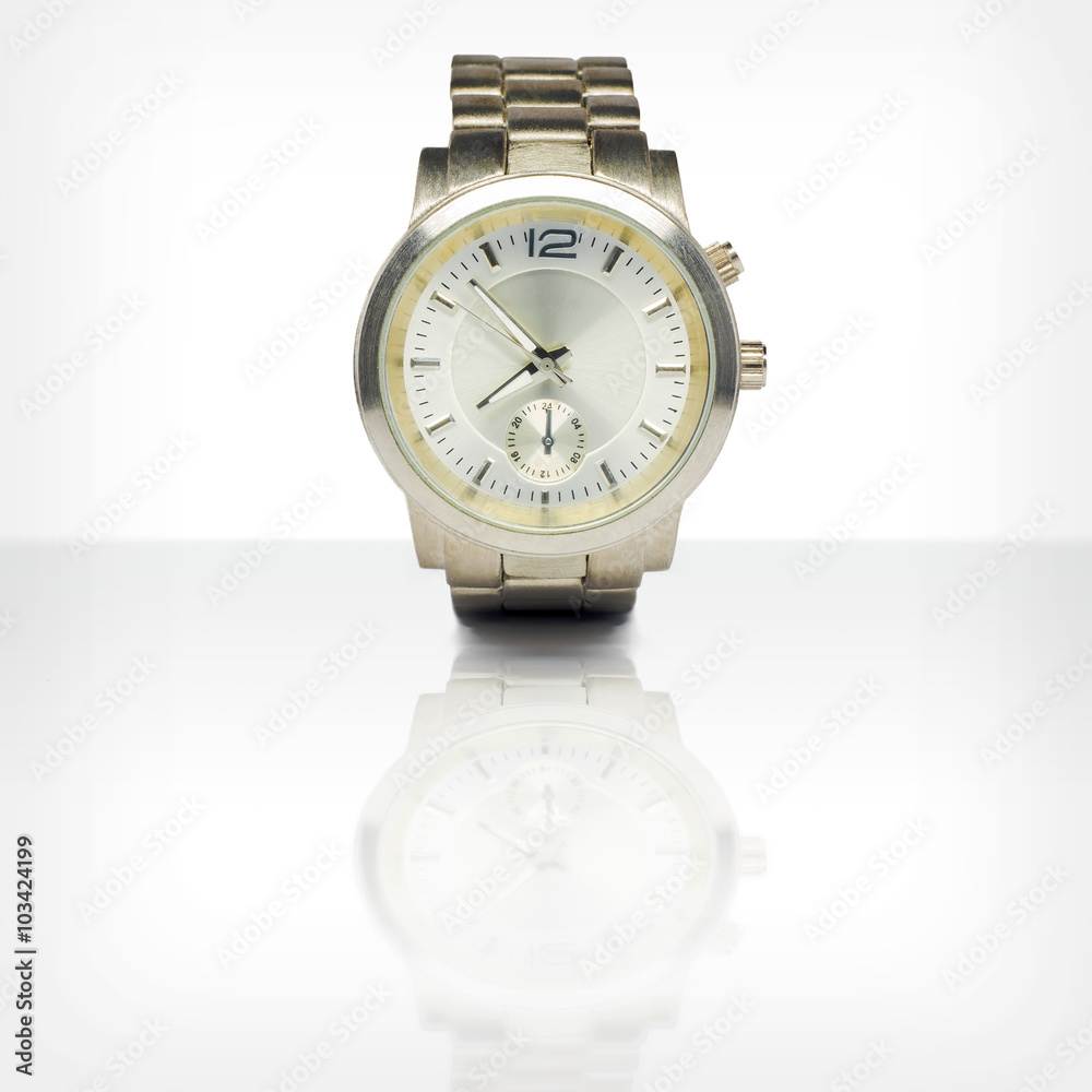 Wristwatch with reflection on white glossy table Wristwatch with reflection on white glossy table