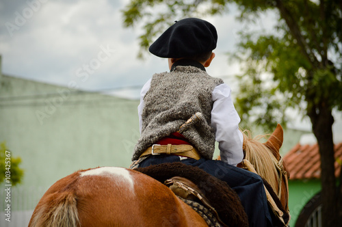 Niño gaucho a caballo photo