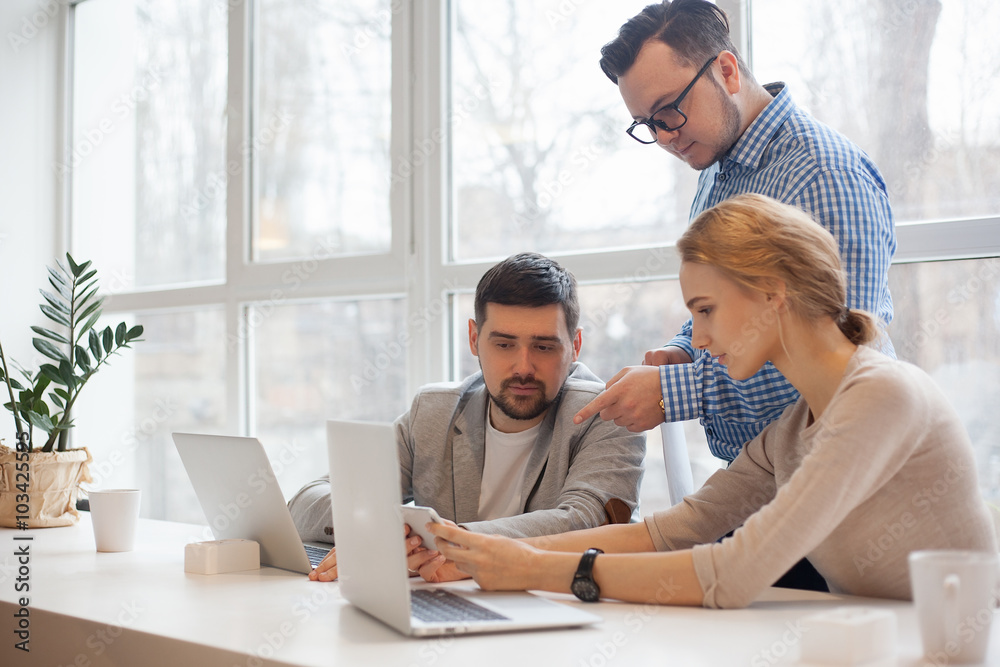 team of three coworkers in stylish studio team of three coworkers in stylish studio