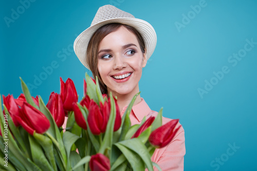 Young beautiful woman studio portrait with tulip flowers photo