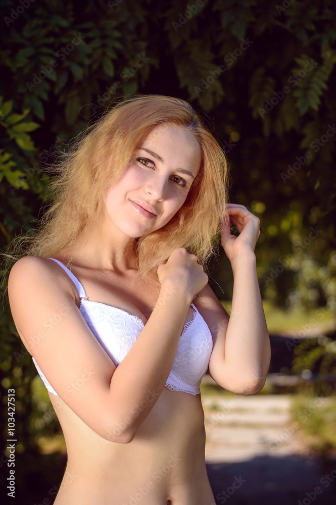 Expressive portrait of a beautiful girl in lingerie posing outside Expressive portrait of a beautiful girl in lingerie posing outside