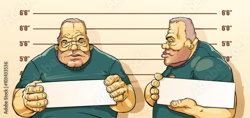 Caughted criminal stands beside wall with number in hands. His take pictures for police documents.