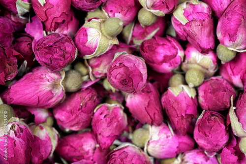 Rose tea - dried rosebuds flowers texture closeup. Dry roses petals for Asian tea and spices. Copyspace for element or background. photo