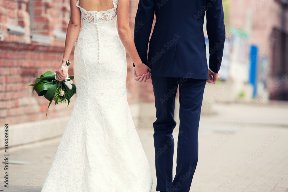 groom and bride walk around the city groom and bride walk around the city