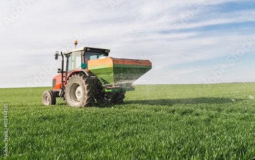 Tablou pe pânză tractor fertilizing in field