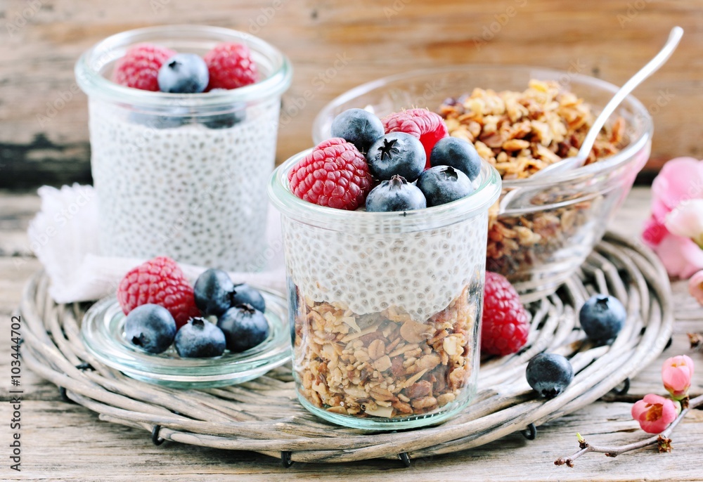 Superfoods concept : overnight chia pudding with homemade granola,fresh berries and honey. Healthy eating. Selective focus Superfoods concept : overnight chia pudding with homemade granola,fresh berries and honey. Healthy eating. Selective focus