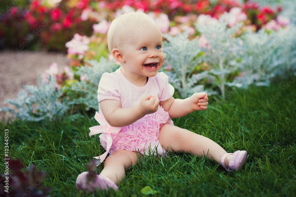 Smiling portrait cute baby-girl on green grass Smiling portrait cute baby-girl on green grass