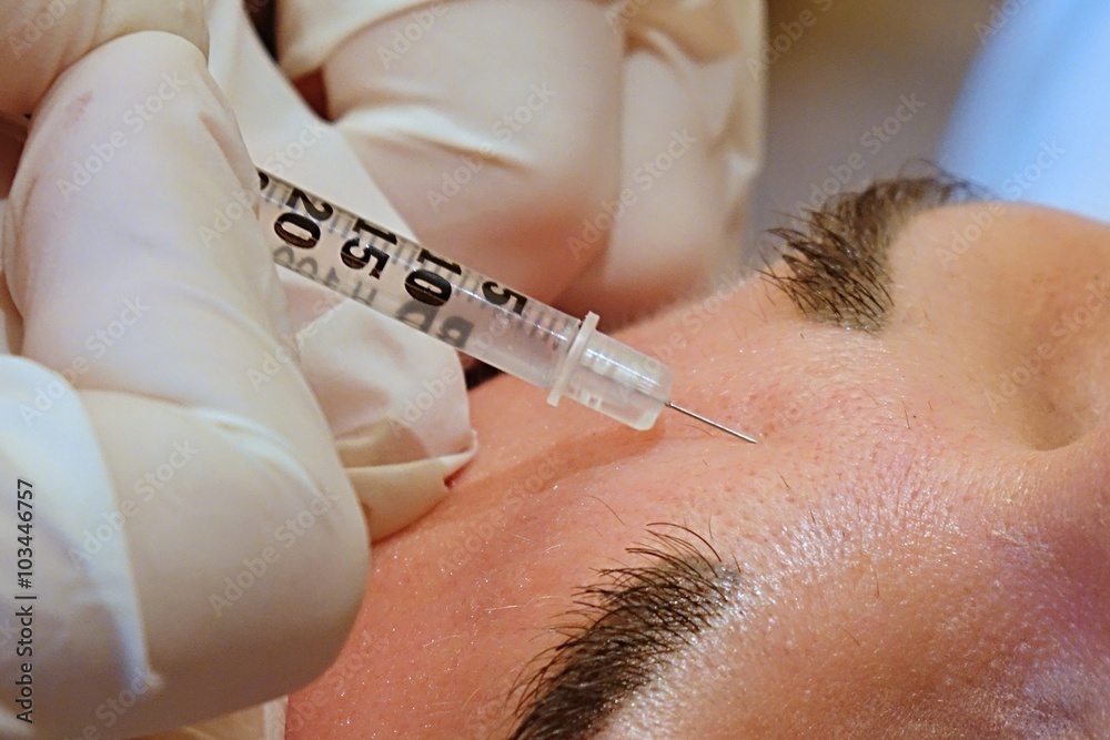 Close-up forehead anti-wrinkle treatment with syringe Close-up forehead anti-wrinkle treatment with syringe