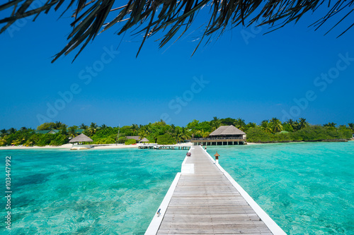 Wooden pier with blue sea and sky background © gawriloff