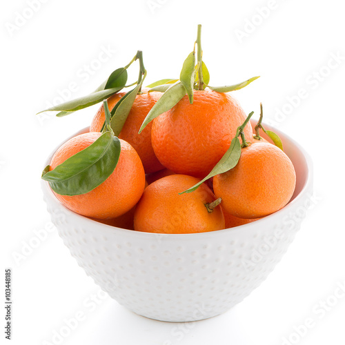 Tangerines on ceramic white bowl
