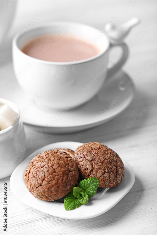Cup of cocoa with chocolate chip cookies and mint on light background Cup of cocoa with chocolate chip cookies and mint on light background