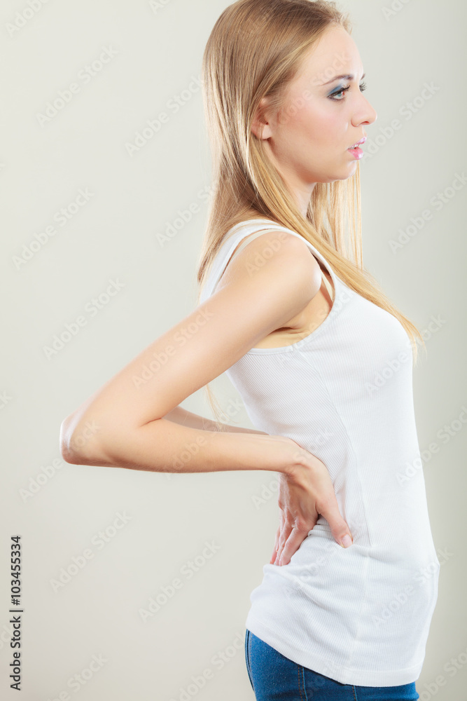 Backache. Young woman suffering from back pain Backache. Young woman suffering from back pain