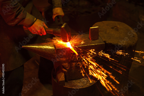 Blacksmith forfing hot iron