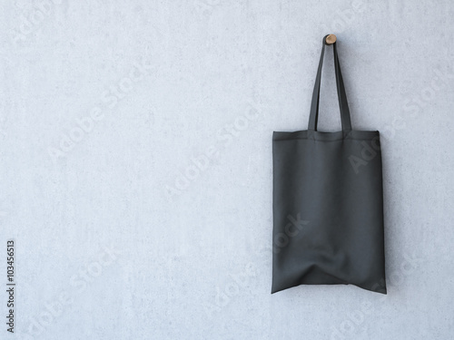 Black cotton bag on the concrete wall. 3d rendering