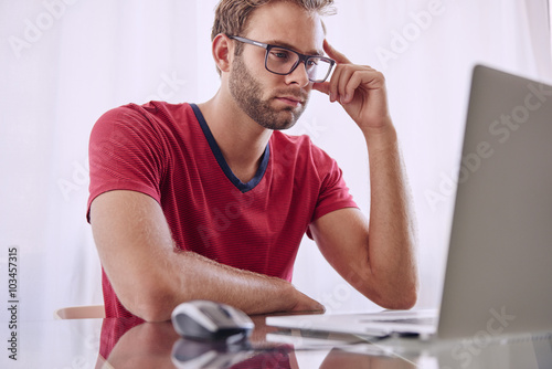 Man deep in concentration infront of computer